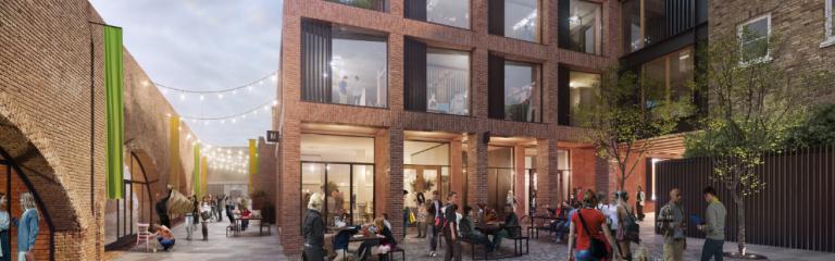 Quirky housing complex with people talking, eating and sitting at picnic tables