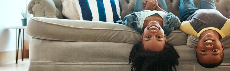 Two foster children playing on a sofa