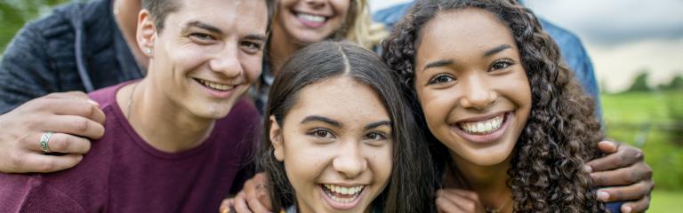 Ethnically diverse group of teenagers smiling